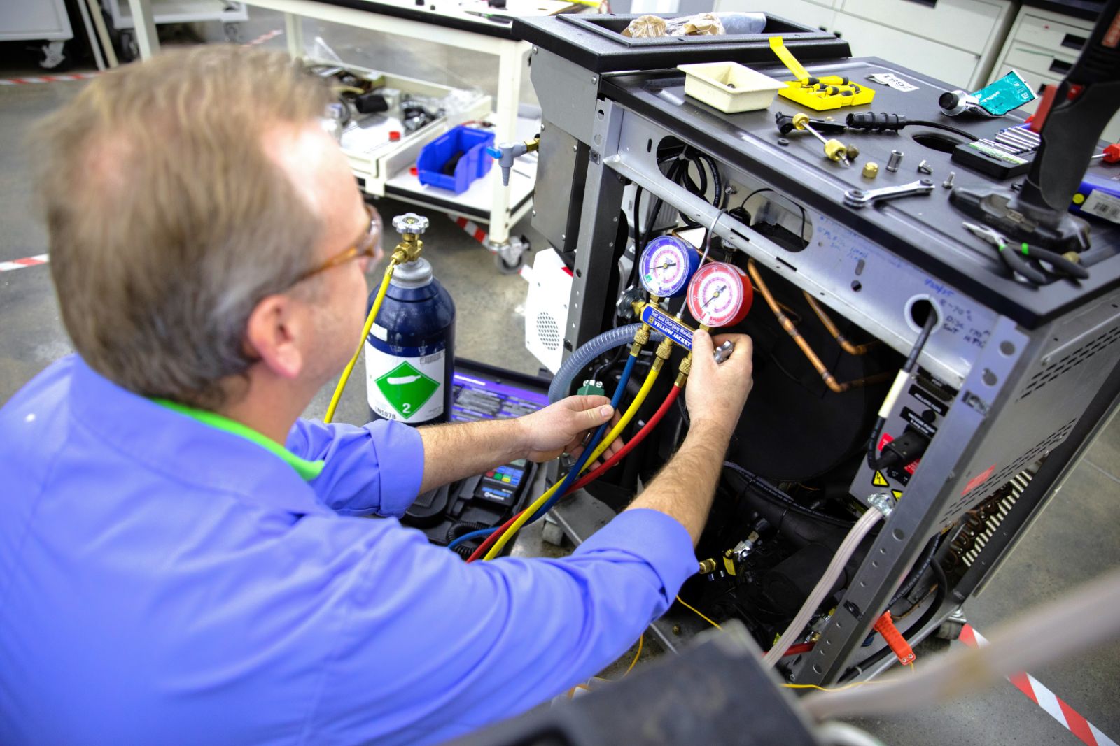 New Life Scientific technician working on an a piece of equipment