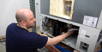 New Life Scientific technician working on an ULT freezer