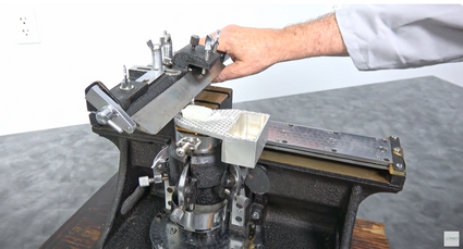 a person is working on an American Optical Spencer model 860 sliding microtome